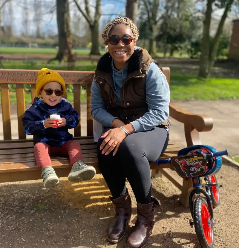 Coach Jessie sitting outdoors with her son